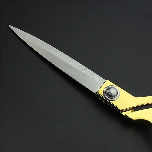 Sharp golden tailoring scissors, perfect for cutting fabric. Sharp golden tailoring scissors, perfect for cutting fabric.